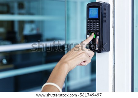 officer scan finger print for enter security system Royalty-Free Stock Photo #561749497