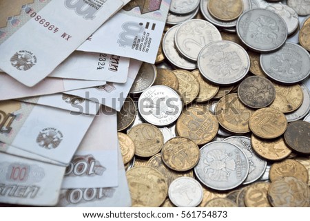 russian hundred-ruble banknotes on the coins of various denominations