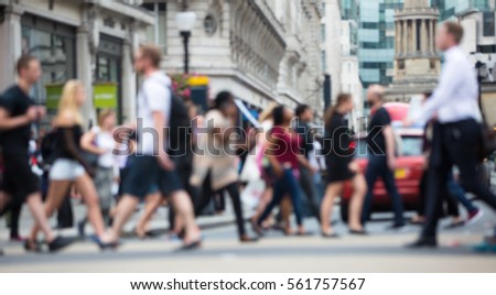 Regent street with lots of walking people crossing the road. Blurred image for background