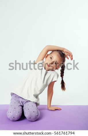 Little girl makes sports exercises. The concept of sport and a healthy lifestyle