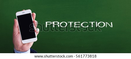 Smart phone in hand front of blackboard and written PROTECTION