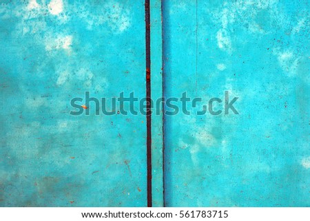 The bright retro blue color old door texture, grunge background with free space.