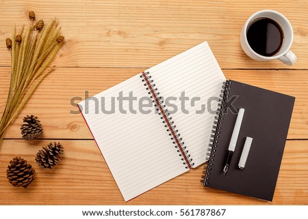 Office desk table with pen  cup of coffee and flower. Top view with copy space