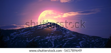 Ukraine Carpathians Montenegrin Mountains  moon rising over the ancient stone altitude Polish Abandoned observatory on a background of snow-capped mountains Pip Ivan Chernogorsky