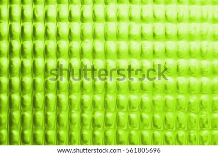 Abstract background of blurred dotted textured semi transparent glass olive green color