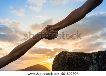 Giving a helping hand.  Royalty-Free Stock Photo #561807709