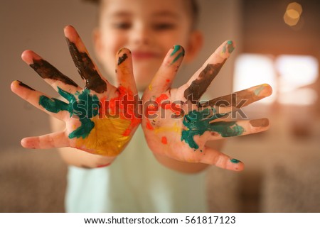 Hands covered in tempura paint. Focus is on hands.  Royalty-Free Stock Photo #561817123