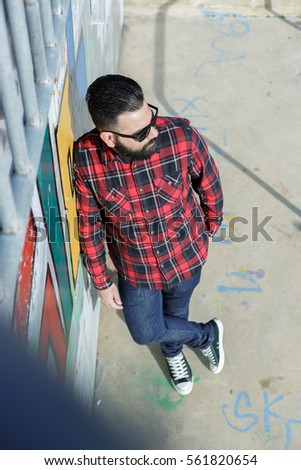 bearded man in squares shirt outdoors
