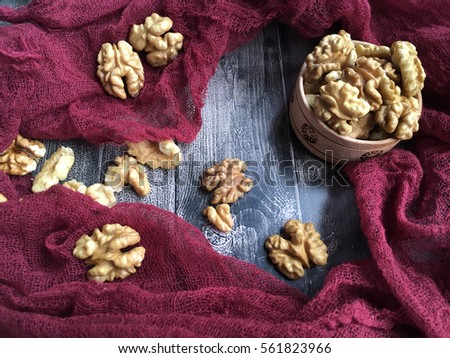 Walnuts. Many walnuts on red background. Rustic walnuts for instagram. 