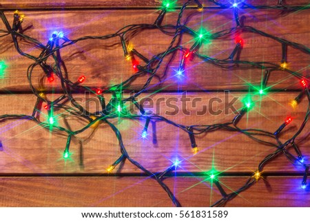 Valentines or christmas romantic lights on wood background. Star filter effect.
