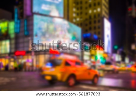 New York City night street scene defocused blur with lights and taxi. 
