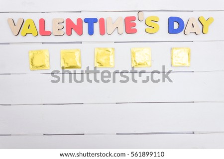 Valentine's Day inscription of colored wooden letters on white background,