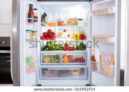 Open Refrigerator Filled With Fresh Fruits And Vegetable Royalty-Free Stock Photo #561902914
