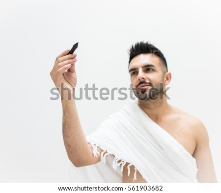 Muslim man posing as ready for Hajj visiting Kaaba in Mecca writing copy space for your text