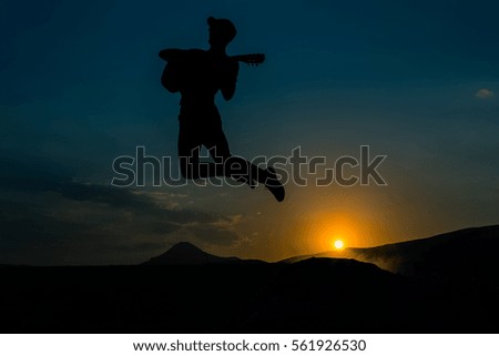 bouncing boy at sunset silhouette