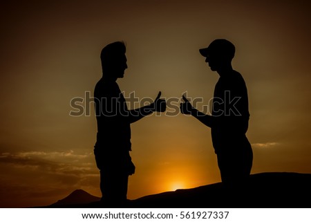against the background of celebrating at sunset silhouette