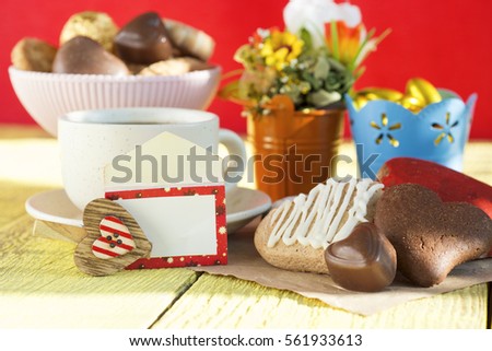 Heart shaped cookies (big and small as couple), cup of coffee, bouquet of flowers decoration. sunny morning. Romantic breakfast or Valentine's Day Breakfast. Toned image