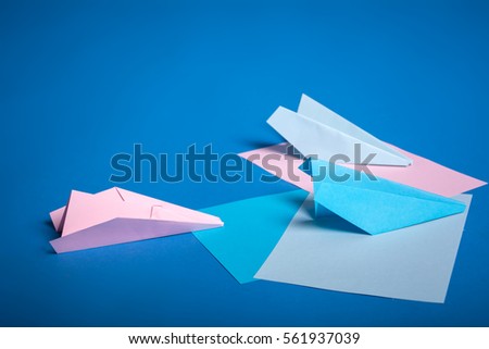 Place for making origami paper planes. Blue, blue, pink origami airplanes crafts.
