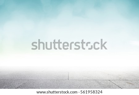 Perspective cement table shelf on therapy spring wallpaper teal color background over blurry blue sky concept for road pattern, hope christmas texture, cloud Relax turquoise garden floor summer shot Royalty-Free Stock Photo #561958324
