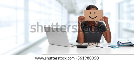 Business woman with smiling cardboard on face