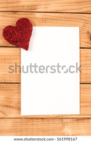 Heart and blank paper on wooden desk for Valentines day