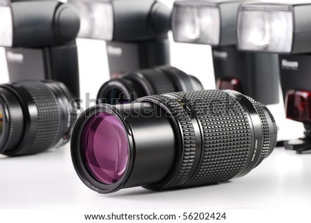 Composition with photo zoom lenses and camera flash on white