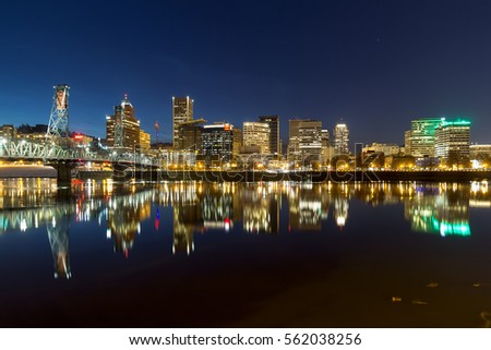Portland Oregon downtown city skyline reflection on Willamette River during evening blue hour