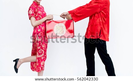 Asian couple with red pocket for Chinese new year wear cheongsam with gift