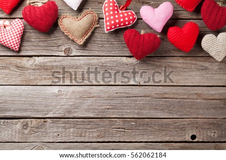 Valentines day greeting card. Handmaded hearts on wooden table. Top view with copy space  