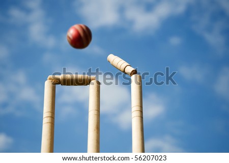 Cricket stumps and bails hit by a ball