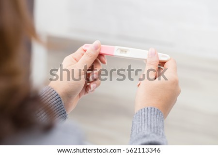 Woman holding pregnancy test, New life and new family concept. Royalty-Free Stock Photo #562113346