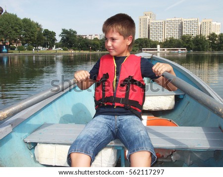 boy riding on a boat in summer