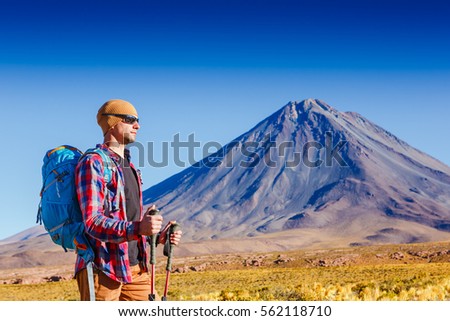 Hiker looking at view during a hiking trip with beautiful volcano landscape