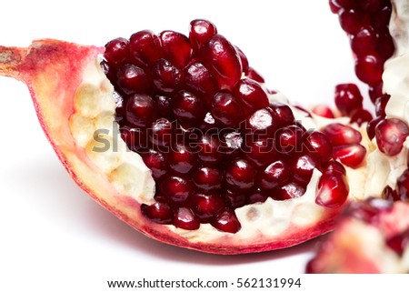 delicious pomegranates with seeds on white background