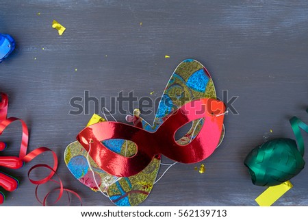 Masquerade  decorations and masks on dark wooden background