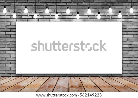 Blank white frame on brick wall and wooden with bulb lights lamp. nice brick show room with spotlights. 