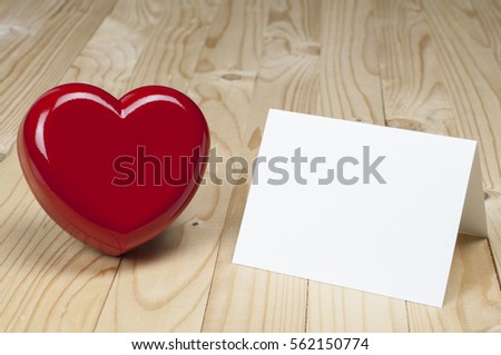Red heart beside white blank card. Valentines and Love concept.