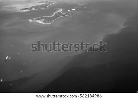 Aerial view of Earth from airplane with black and white filter