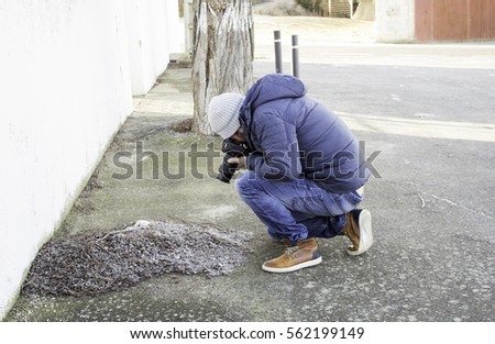 Man making photos on leaves street 