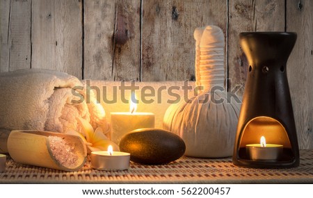 burning candles in spa wellness Royalty-Free Stock Photo #562200457