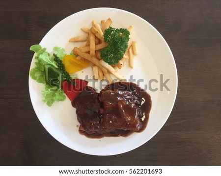 Delicious barbecued ribs with spicy sauce and organic salad, stock photo
