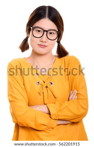Studio shot of young angry Asian woman with arms crossed