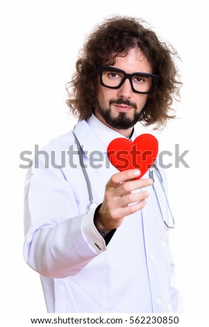 Studio shot of handsome man doctor holding red heart