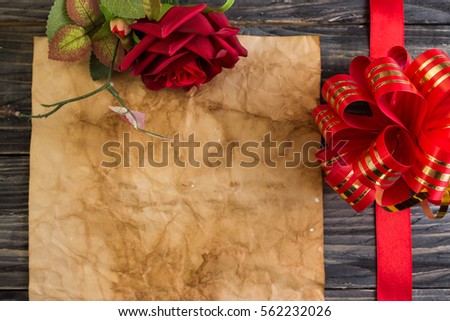 Wooden background in rustic style, with red ribbon and bow.