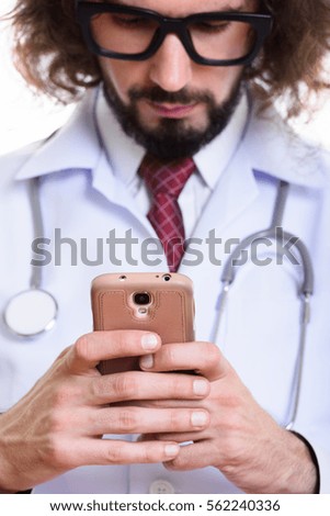 Close up of handsome man doctor using mobile phone with focus on phone