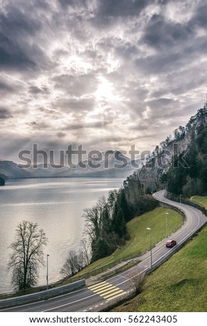 Landscape spring, a view of the sunrise on the mountain lake, sky and the road. Switzerland