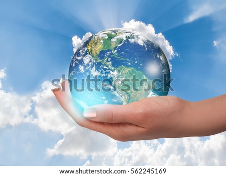 Woman holding globe on her hand. Elements of this image furnished by NASA