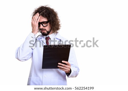 Studio shot of stressed man doctor holding clipboard