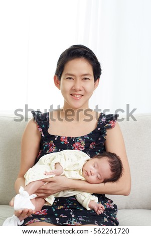 Young East Asia mom and her sleeping baby