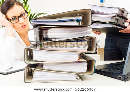 Overworked Secretary With Folders